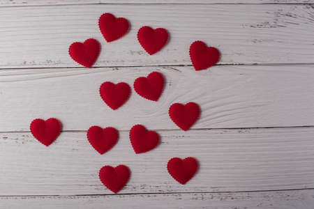 Red heart on white wood badkground