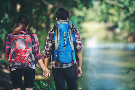 Hiking couple in forest together. Adventure travel vacation. Happy time hiking.の写真素材