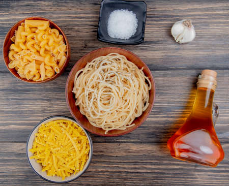 top view of different macaronis as spaghetti tagliatelle and others with salt garlic melted butter...