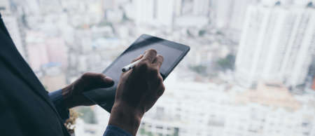 business man working successful with tablet, the background of urban city