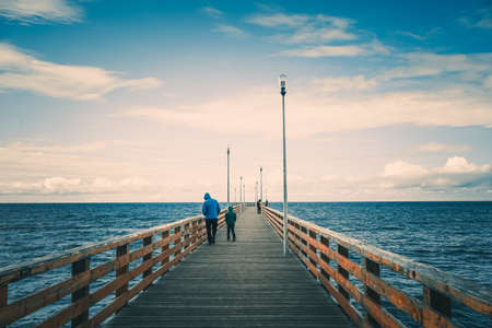 Zelenogradsk, Russia. Seascape overlooking the long pier of the resort town with walking people.の写真素材