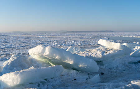 Ice blocks on the background of the frozen sea.