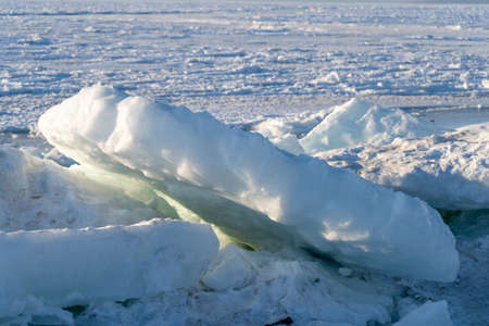 Ice blocks on the background of the frozen sea.