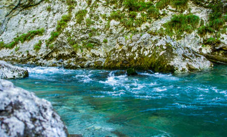 Rocky shore of a mountain river with clear water. Beauty of nature