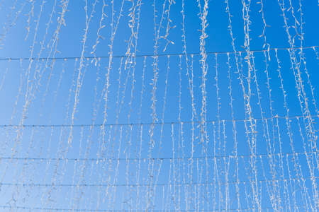 Christmas garlands on a blue sky background. Festive interior.
