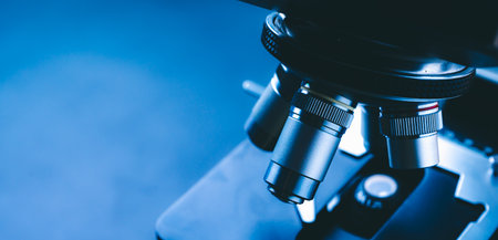 Laboratory equipment optical microscope, closeup of scientific microscope with metal lens, data analysis in the laboratoryの写真素材
