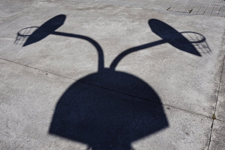 street basketball hoop shadow silhouette on the court