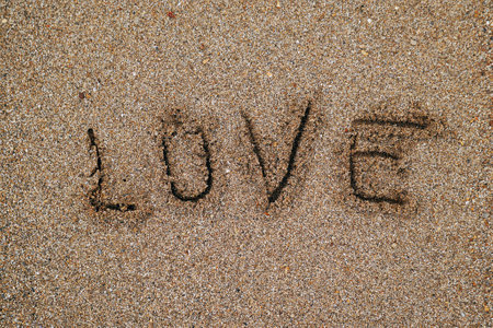 love written on the sand in the beachの写真素材
