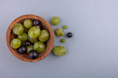 top view of grape berries in bowl on gray background with copy spaceの写真素材
