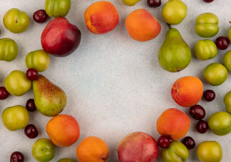 top view of pattern of fruits as plum peach and pear cherry on white background with copy spaceの写真素材
