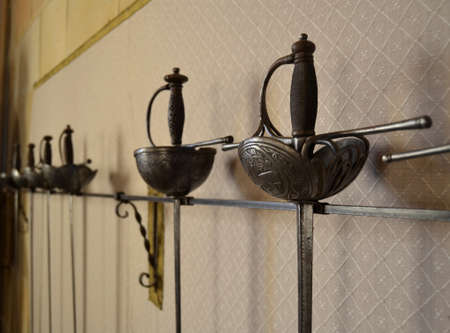 Stored sabers and swords hanging on the wall for display