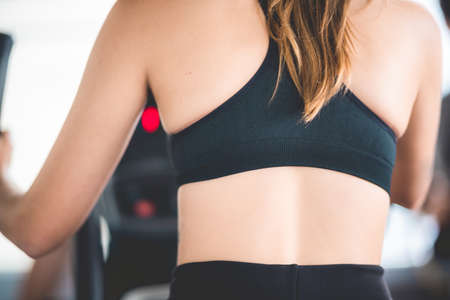 young slim sexy sporty woman model exercise with black sportswear working out in fitness gymの写真素材
