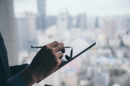 business man working successful with tablet, the background of urban cityの写真素材