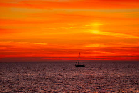 Seascape with a bright orange sunset.の写真素材
