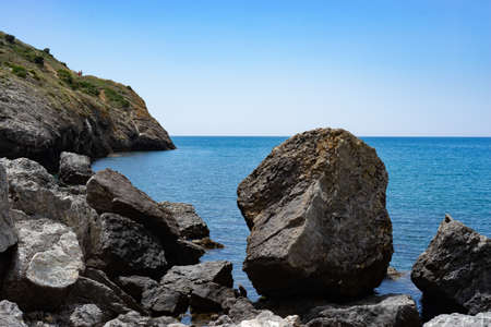 Seascape with rocks on the background of water. Sudak, Crimeaの写真素材
