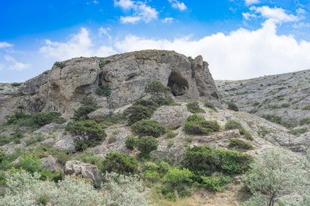Natural landscape with rocks covered with vegetation against a blue sky. beauty of natureの写真素材