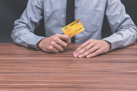A man holding a credit cardの素材