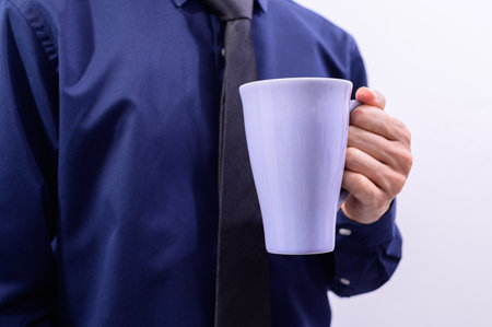 A man holding a coffee cupの素材