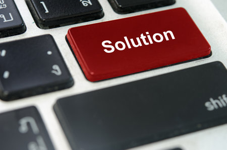 A keyboard with a red button Solution..の素材