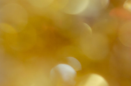 Abstract blurred yellow bokeh on backgroundの素材