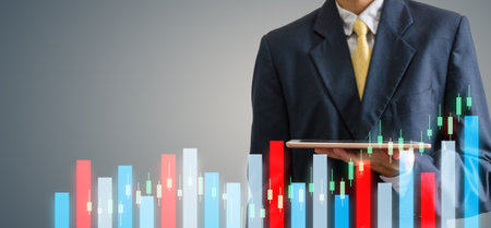 hand Business man holding with a tablet.Stocks Exchange Market Graph Conceptの素材