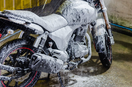 Motorcycle foam wash at the car wash shop cleaningの素材