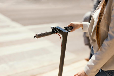 Young woman rides in a electrical scooter in the cityの素材