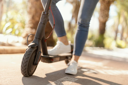 Young woman rides in a electrical scooter in the cityの素材