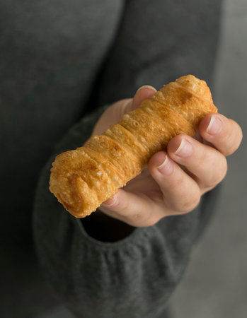 Woman holding traditional tequenos dishの素材