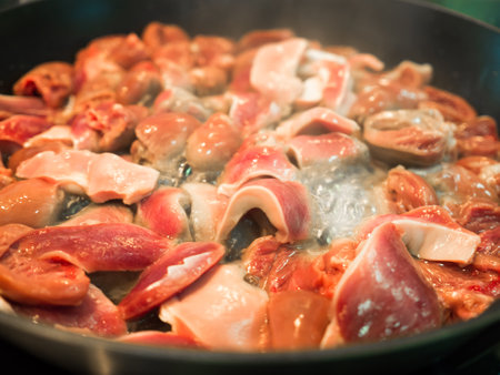 Close up of Asian food cooked chicken hearts fried in pan.の素材