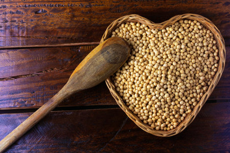 raw and fresh soy beans inside basket with heart shape on rustic wooden tableの素材