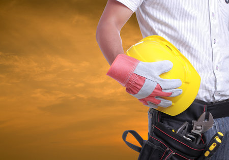 Worker holding tool with Twilight time on Labour Dayの素材