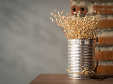Flowering dried grass in aluminium pot for room decoration.の素材