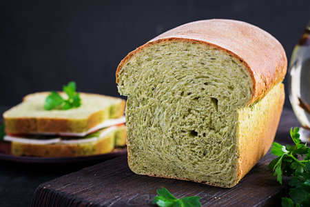 Spinach bread and a sandwich with cheese, tomatoes and herbs. Healthy lunch.の素材