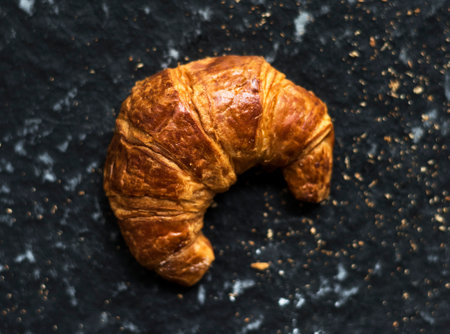 Crossiant butter single on black backgroundの素材