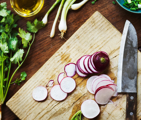 Closeup of fresh radish on wooden cut boardの素材
