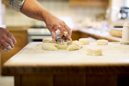 Caucasian man baking scones at homeの素材