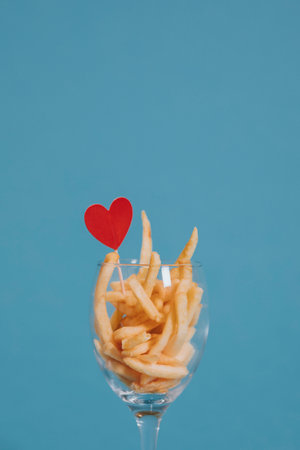 French fries in a wine glass with a heart ornamentの素材