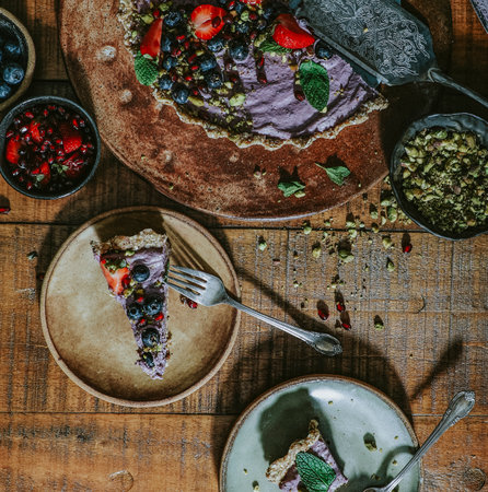 Sliced sweet potato tart topped with strawberries and blueberriesの素材
