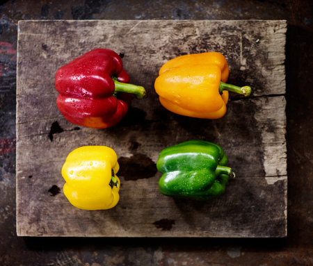 Aerial view of various bell peppers on wooden backgroundの素材