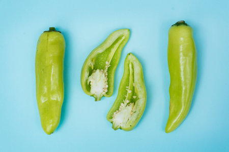 Aerial view of fresh jalapeno peppers on blue backgroundの素材