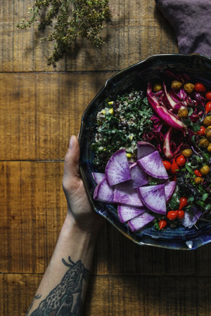 Woman having organic buddha bowl for lunchの素材