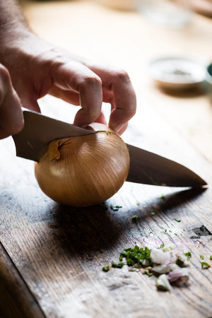 Onion being cut for cookingの素材