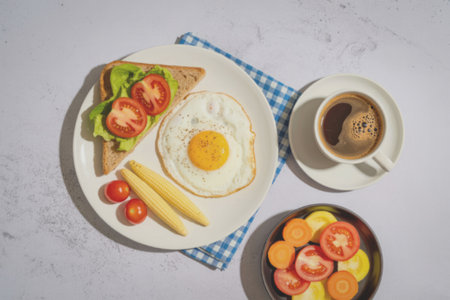 A well-balanced breakfast featuring a fried egg, toast with vegetables, a cup of coffee, and a bowl...