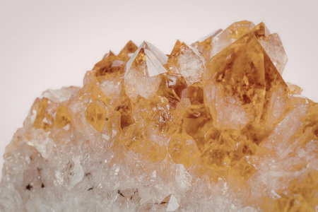 A detailed image of a citrine crystal cluster, showcasing its vibrant orange and white crystalline...