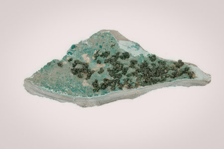 A mineral rock formation with a unique shape and texture, featuring a mix of light and dark green...