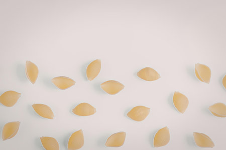 a collection of small yellow seeds scattered on a white surface