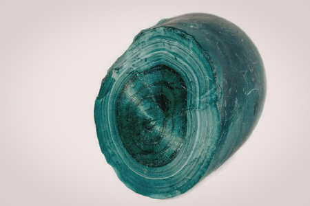 A roll of green wire mesh on a white background