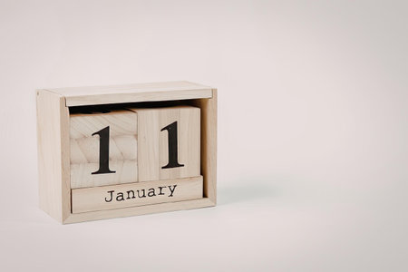 A wooden perpetual calendar displaying the date January 11.
