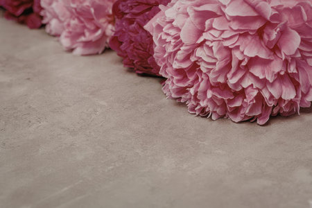 A close-up view of pink flowers resting on a gray surface, likely a table or countertop.